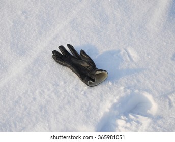 Black Leather Glove Lose And  Buried In Snow