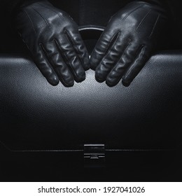 Black leather gloves. Briefcase in black leather. Business style. Black background. - Powered by Shutterstock