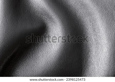 Black leather jacket as an abstract background. Texture.