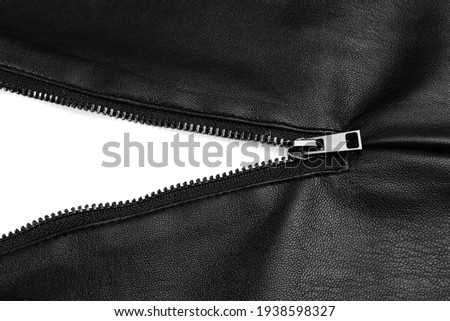 Black leather jacket with zipper on white background, top view