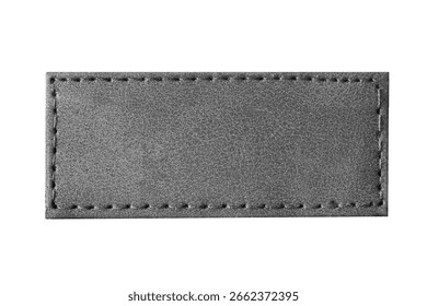 Black leather label closeup. Rectangular stitched patch isolated on white background. Blank tag for branding or design. Smooth texture of genuine leather. Fashion accessory or garment element.