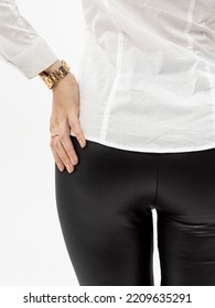 Black Leather Leggings On White Background. Woman In White Shirt And Black Jeggings. Tight Fit