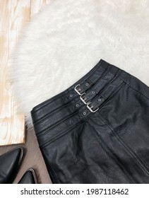 Black Leather Mini Skirt Close Up On Wood Background