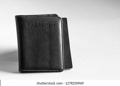 Black Leather Passport Holder With Passport Inside Isolated On Background