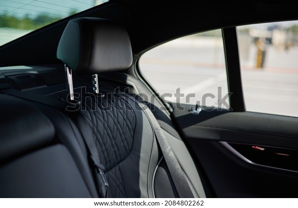 Black leather rear seat\
of a luxury car