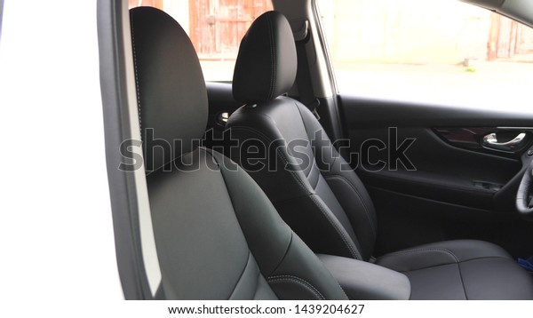 Black leather seat covers in car.\
luxurious car interior with black leather\
seats.