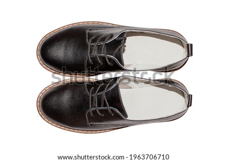 Black leather women's classic shoes with lacing on a white background.Shoes made of black genuine leather with brown soles.