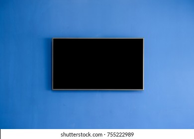 Black LED Tv Television Screen Mockup / Mock Up, Blank On Blue Wall Background In Room For Interior Decoration Design