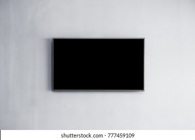 Black LED Tv Television Screen Mockup / Mock Up, Blank On White Wall Background In Room For Interior Decoration Design