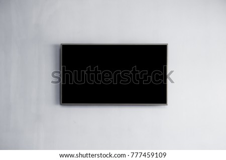 Black LED tv television screen mockup / mock up, blank on white wall background in room for interior decoration design