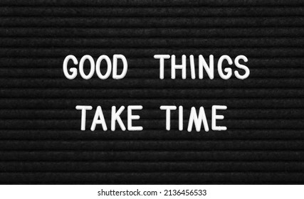 Black letter board with motivational quote Good Things Take Time, closeup view