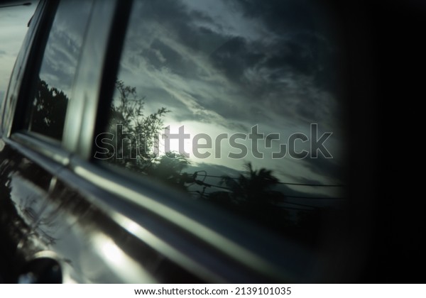 Black light film on the car glass, reflection of\
sunset sky at dusk, blur\
photo