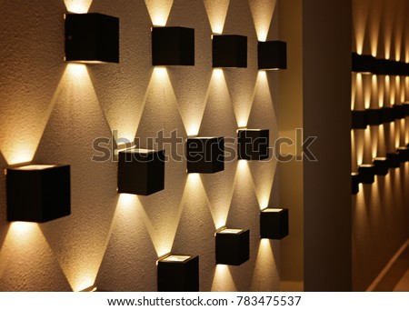 black light in the form of a cube on the wall, perspective, yellow light, a graphic pattern of light.
