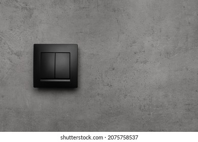 Black light switch on grey background. Space for text