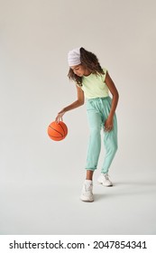 Black Little Girl Playing Basketball In Studio