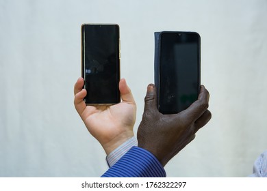 Black Lives Matter. Afroamerican And European Hands Holding Phones Close Together.