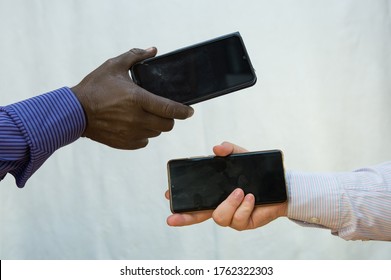 Black Lives Matter. Afroamerican And European Hands Holding Phones Close Together.