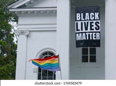A Black Lives Matter banner and LGBT flag displayed outside a church in Lexington, Massachusetts