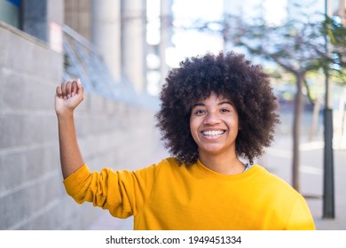 Black Lives Matter Concept. One Serious Young African Or American Woman With Her Arm Up With Close Hand Looking At Camera.