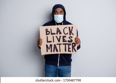 Black lives matter concept. Photo of serious dark skin african poor cold protester placard community against black citizens lawlessness wear hoodie face mask isolated grey color background