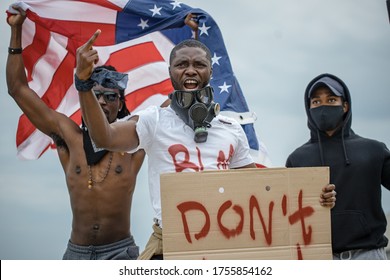 Black Lives Matter Protests Go Global. Three Afroamerican People With Posters In The Street, Black People Dissatisfied With Police Injustice And Government