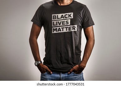 Black Lives Matter T-Shirt. Person Wearing BLM Tee Shirt Design on White Background.