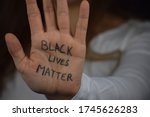 Black Lives Matter written on long haired white woman