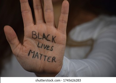 Black Lives Matter Written On Long Haired White Woman's Hand. Caucasian Girl  Against Racism And Police Brutality. Support To African Americans.