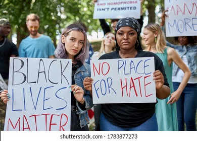 Black Lives Matters Protesters Or Activists In Holding Signs And Marching Outside. Diverse People Demonstrate Their Dissatisfaction With Situation In America Connected With Killing Black People