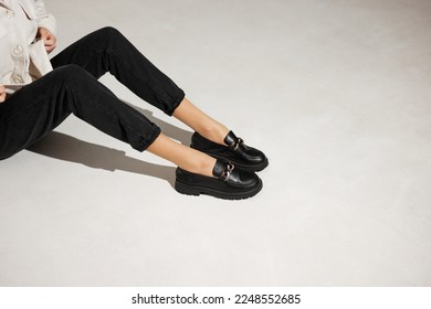 black loafers on female legs close-up - Shutterstock ID 2248552685