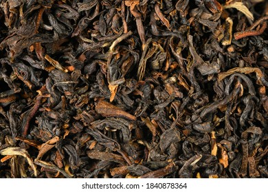 Black loose dry indian tea from Darjeling, India. Closeup macro high resolution background..