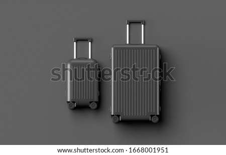 Black luggage set on dark background, top view image, flat lay composition. Travel minimalist concept, black and dark classic baggage mockup, small and big. Suitcase accessory set, journey concept.