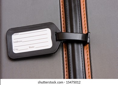 A Black Luggage Tag On A Handle On A Bag