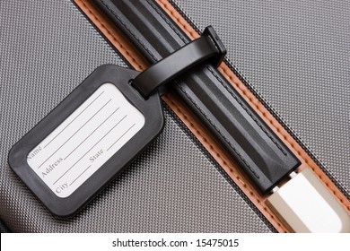 A Black Luggage Tag On A Handle On A Bag