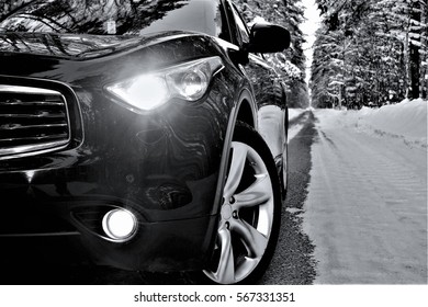 
Black Luxury Car On A Forest Road In The Winter