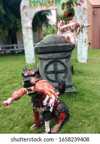 A Black Magic Doll With A Beloved Dog Lying On The Grave.