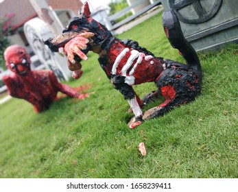 A Black Magic Doll With A Beloved Dog Lying On The Grave.