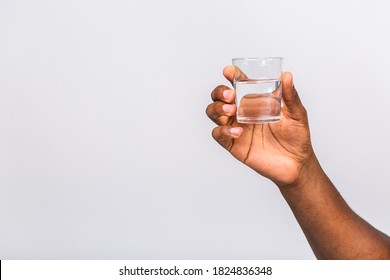 Black Male African American Hand Holding Glass Of Water Isolated On White Background, Closeup, Cutout.