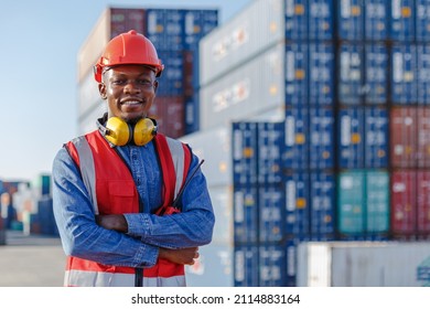 Black male African American smiling engineering in uniform wear hard hat standing containers yard. Area logistics import export and shipping. - Powered by Shutterstock