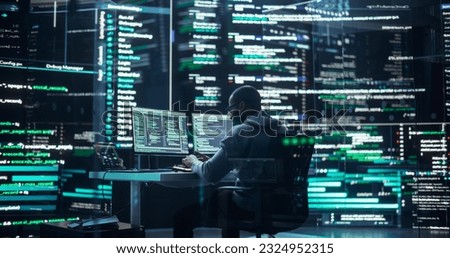 Black Male Developer Thinking and Typing on Computer, Surrounded by Big Screens Showing Coding Language. Professional Programmer Creating Software, Running Coding Tests. Futuristic Programming Concept