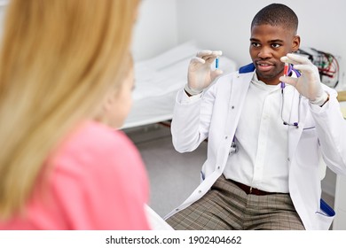 Black Male Doctor Have A Nice Talk With Kid Girl, Showing Colourful Modern Capsules To Her, He Disposes, Work With Children In Hospital