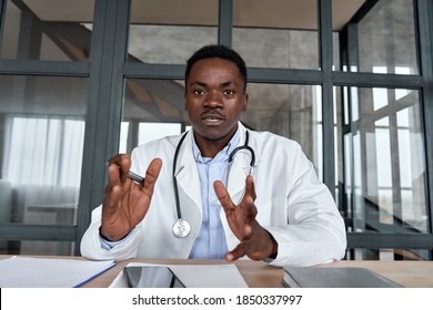 Black Male Doctor Talking To Web Cam Consulting Patient Via Virtual Telemedicine Advice. African Physician Making Online Telehealth Video Call For Remote Appointment Tele Health Care Chat. Webcam View