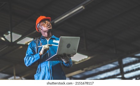 Black Male Electrician Engineer Working With Laptop Computer Tool In His Hands. Maintenance Service Repair Concept