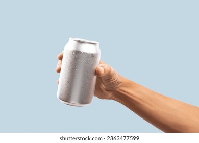 Black male hand holding aluminum can on cyan background