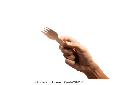 Black male hand holding a disposable wooden fork isolated no background - Shutterstock ID 2364628817