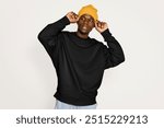 Black male model wearing yellow beanie 