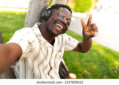 Black Male Teen With Glasses Taking Selfie On Campus. Happy African American College Student Looking At Camera Outdoors.