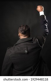 Black Man From Behind With Raised Fist.