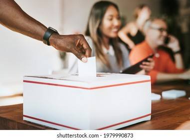 Black Man Casting His Vote To A Ballot Box