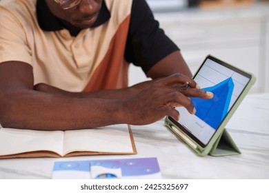 Black man checking retirement plan chart on tablet screen